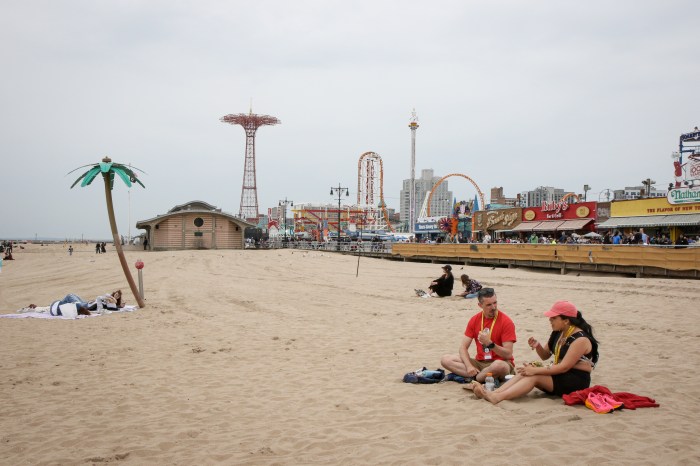 people on beach after brooklyn half marathon