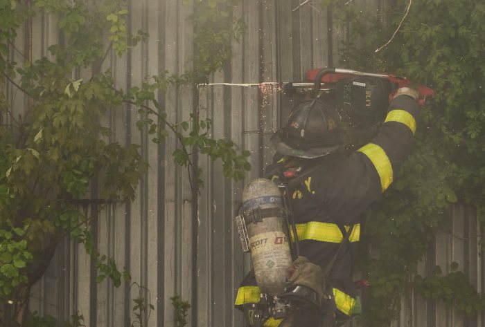 firefighter using saw in east new york