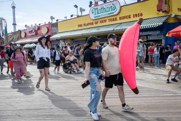people with giant banana on coney island boardwalk