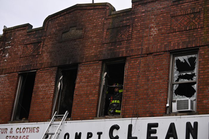 firefighters inside damaged midwood apartment