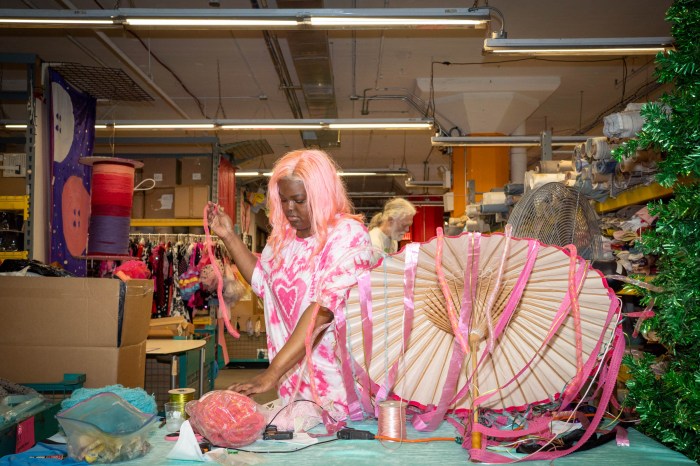 MTFA employee decorating umbrella for Mermaid Parade