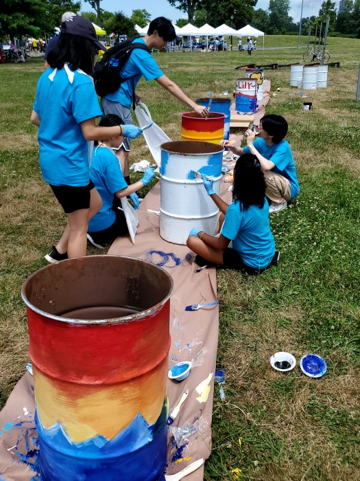 Young volunteers use their creative talents to paint new barrels for the area.