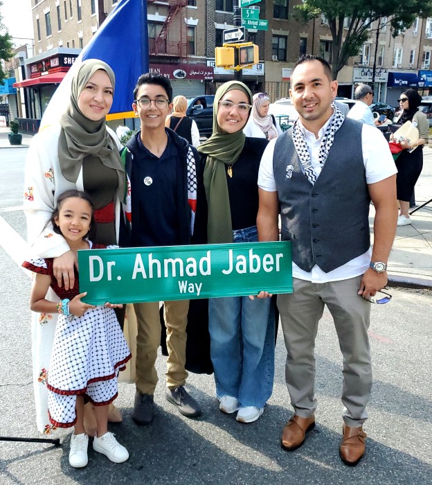 Families joined at the intersection to share kind words on the late humanitarian's work.