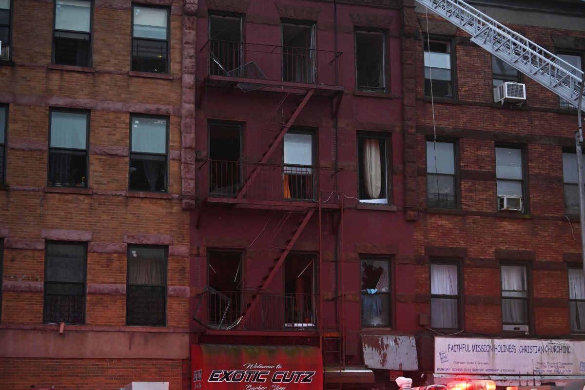 A firefighter  and FDNY EMS Paramedics work to resuscitation a cat found in the basement following a fire set by an  emotional disturbed person at 2204 Fulton Street on Thursday, August 8.. The EDP is in critical condition and a firefighter was left injured.