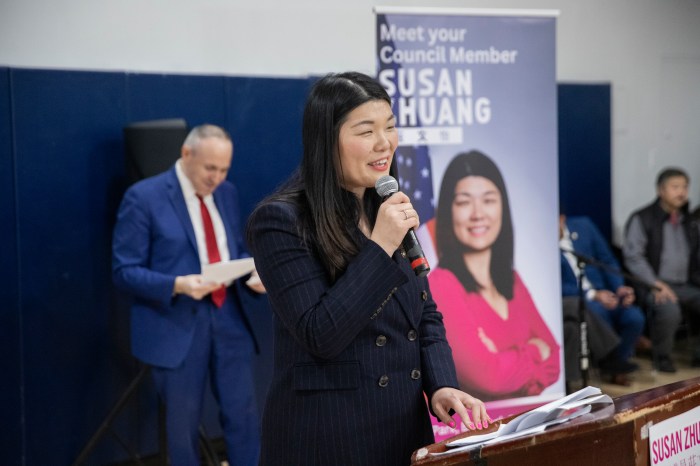 susan zhuang speaks at podium