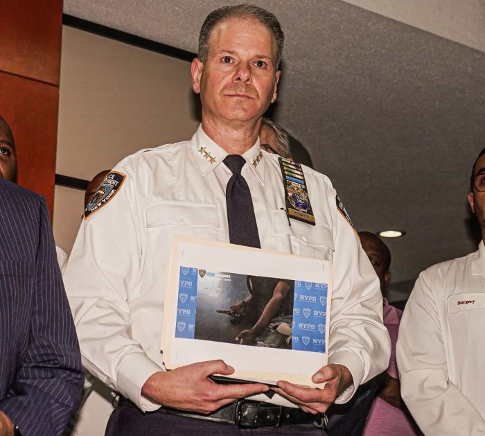 officer holding picture of knife after shooting