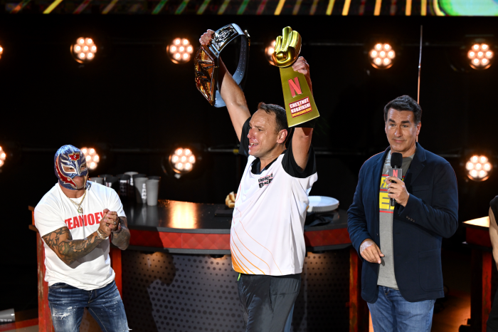 WWE superstars Rey Mysterio presented Chestnut with a WWE-made custom championship title belt after scoffing a world-record breaking 83 hot dogs ad buns