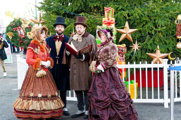 Carolers set the mood with classic holiday tunes.