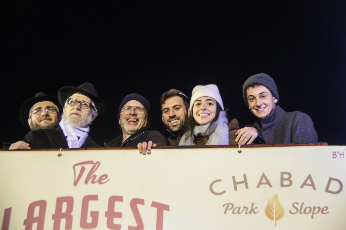 people doing menorah lighting