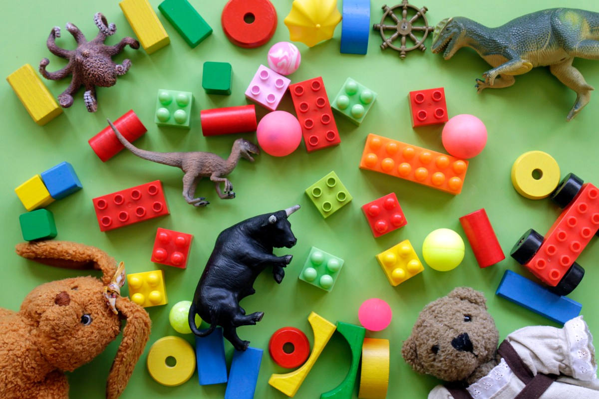 High Angle View Of Toys Over Green Background