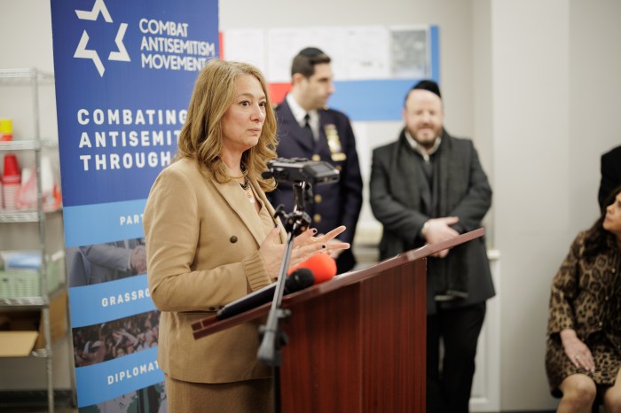 woman talks about antisemitism at podium