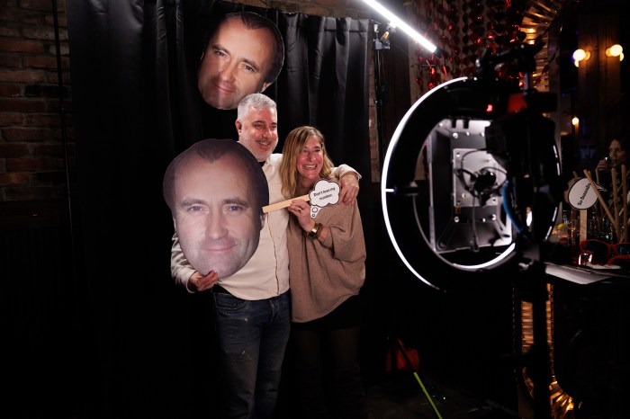 Jonathan Bardo and Yauny Wheaton pose at the photo booth during the annual Phil Collins Day celebration