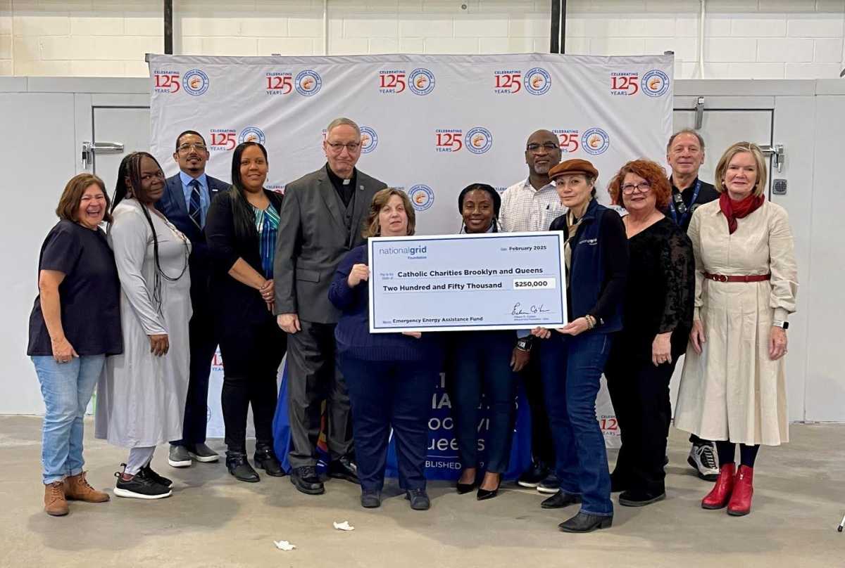 Catholic Charities with a check.