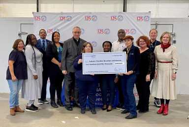 Catholic Charities with a check.