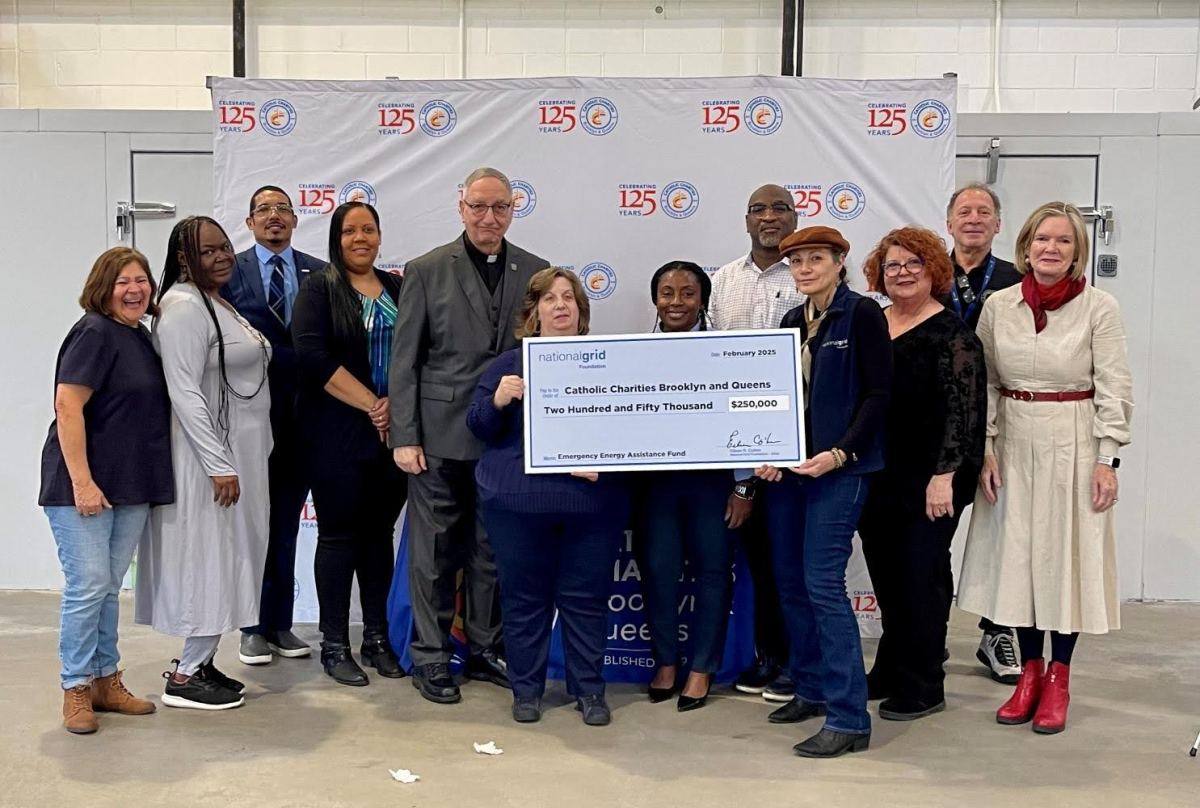 Catholic Charities with a check.