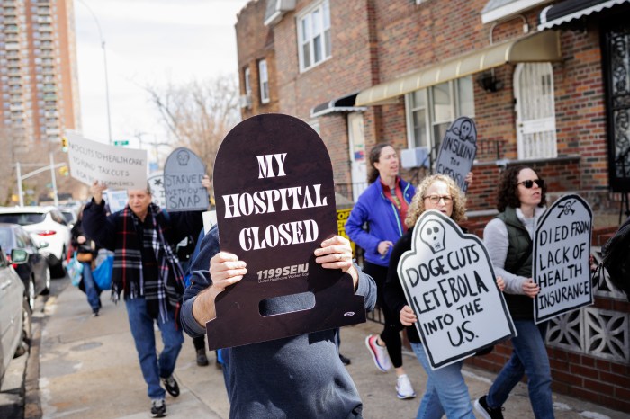 protestors outside malliotakis office with tombstone-shaped signs