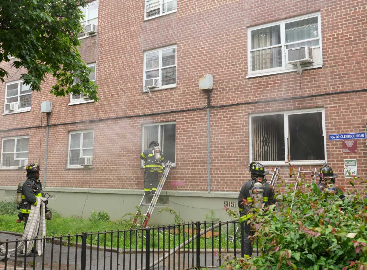firefighters on ladder outside first floor window at breukelen houses