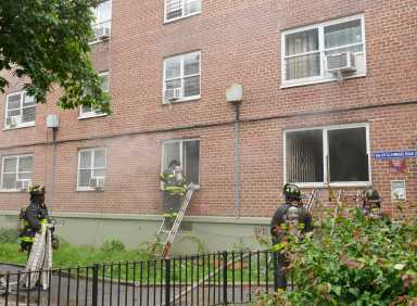 firefighters on ladder outside first floor window at breukelen houses