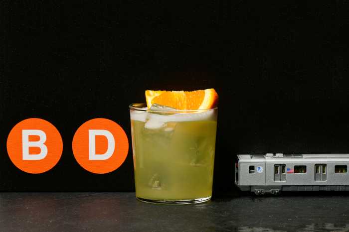BDFM cocktail with orange subway signs and mini subway car