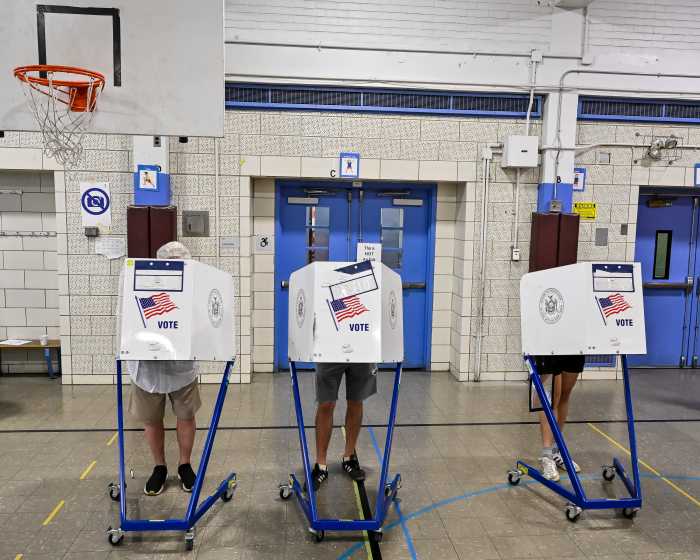 people in voting booths for 2025 primary