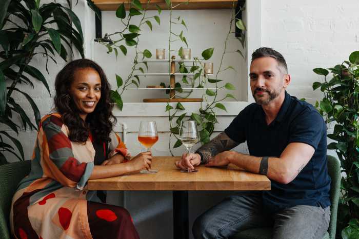 selune founders sitting at table with wine glasses