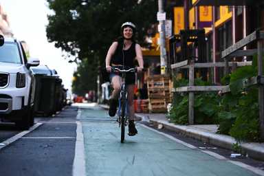 woman riding in bedford avenue bike lane