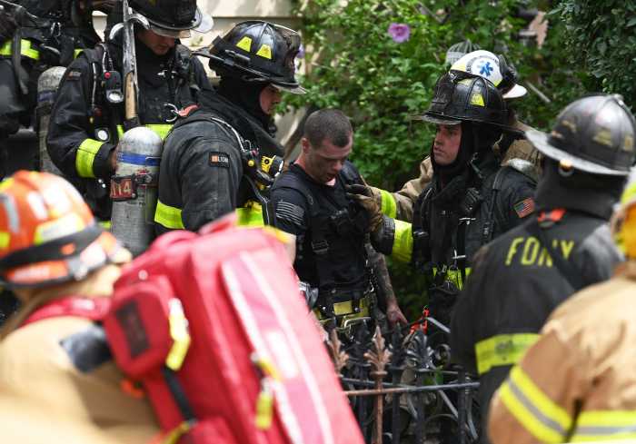 firefighter who was injured is supported by colleagues outside bed-stuy house fire