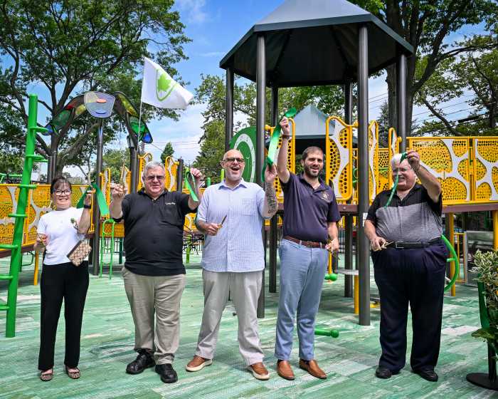 people celebrating ribbon cutting at russell pedersen playground