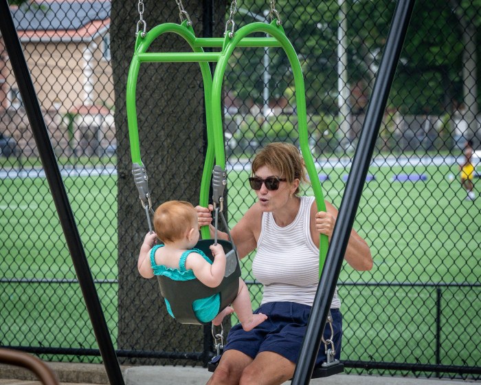 woman on swing with baby at russell pedersen playground