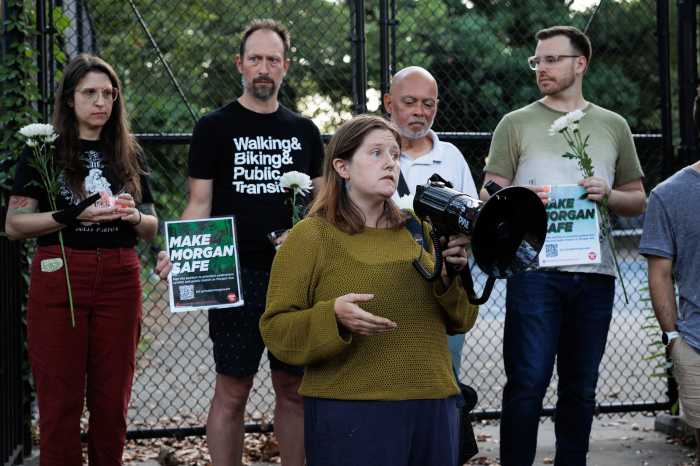 woman speaking at Morgan Avenue vigil in front of small crowd 