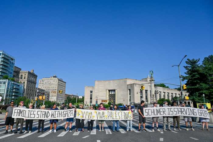 protestors blocking street holding banners