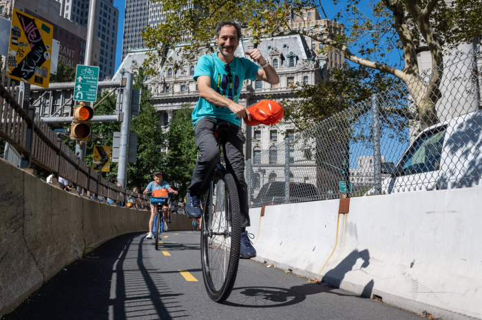 man riding in unicycle festival