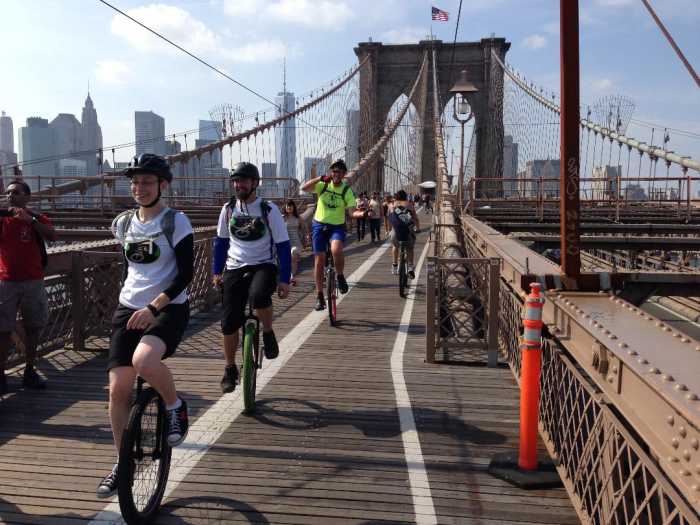 people on brooklyn bridge for unicycle festival
