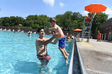 child with parent at public pool brooklyn public library