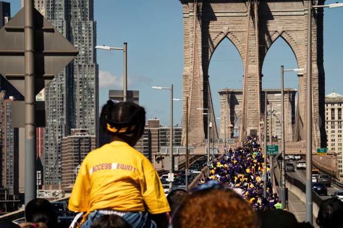 students march across brooklyn bridge