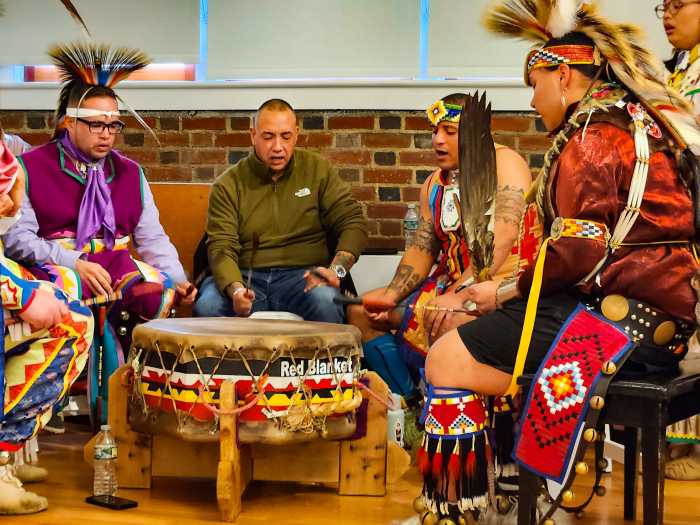 lenape pow wow people singing and playing drum