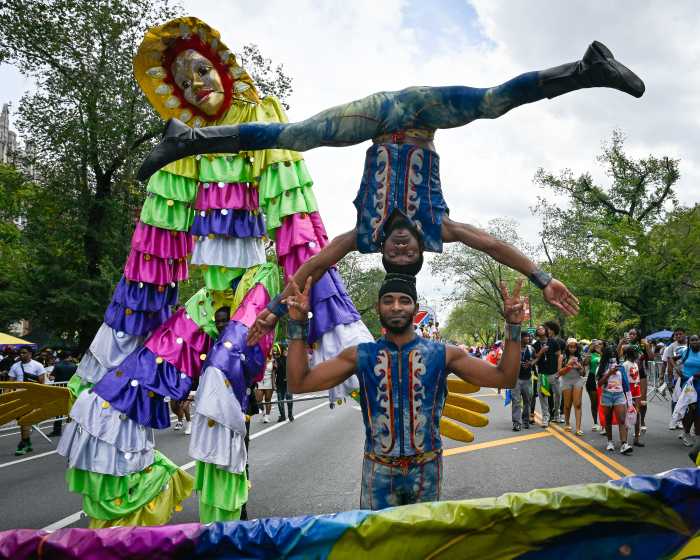 people doing acrobatics at west indian day parade