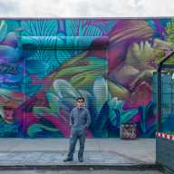 beau stanton in front of bushwick mural