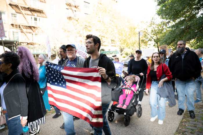 no kings march brooklyn people with american flag and stroller