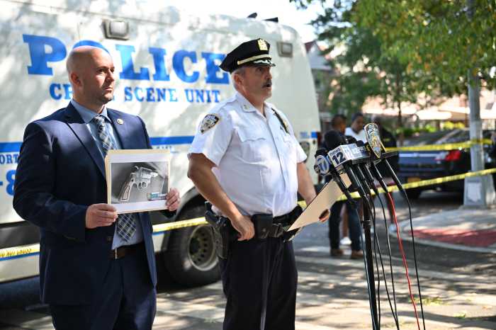 police officer with image of gun on scene of shooting