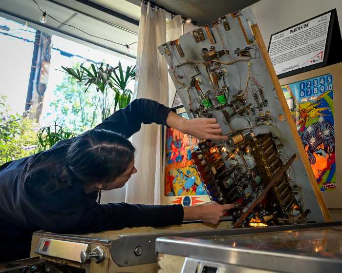 murray holding open pinball machine