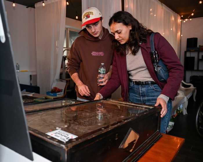 people trying pinball game