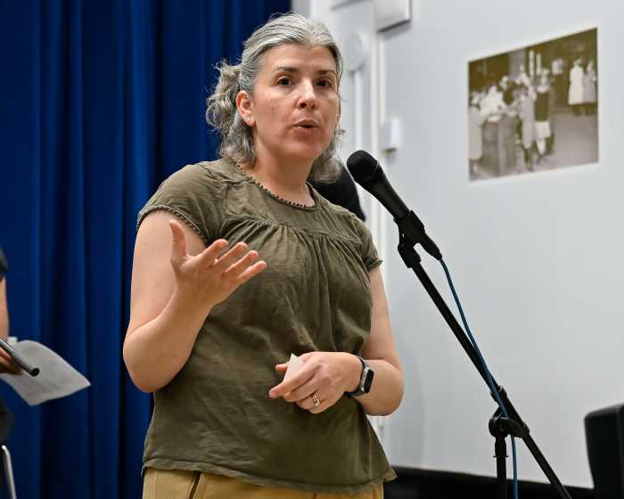 person at community meeting