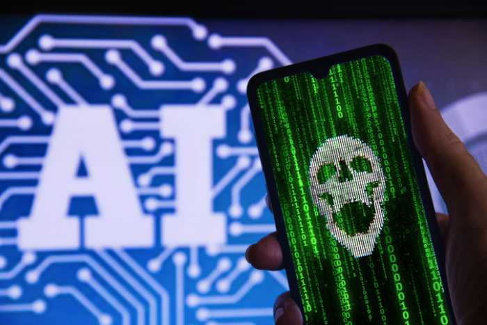 Hand holding a hacked cell phone with a skull (cyber attack), with the Artificial Intelligence (AI) symbol in the background. Concept of cyber attack, hacking and computer crime with AI.