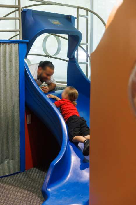 parent on slide at brooklyn children's museum