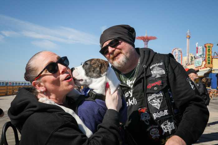 couple with dog at coney island boardwalk